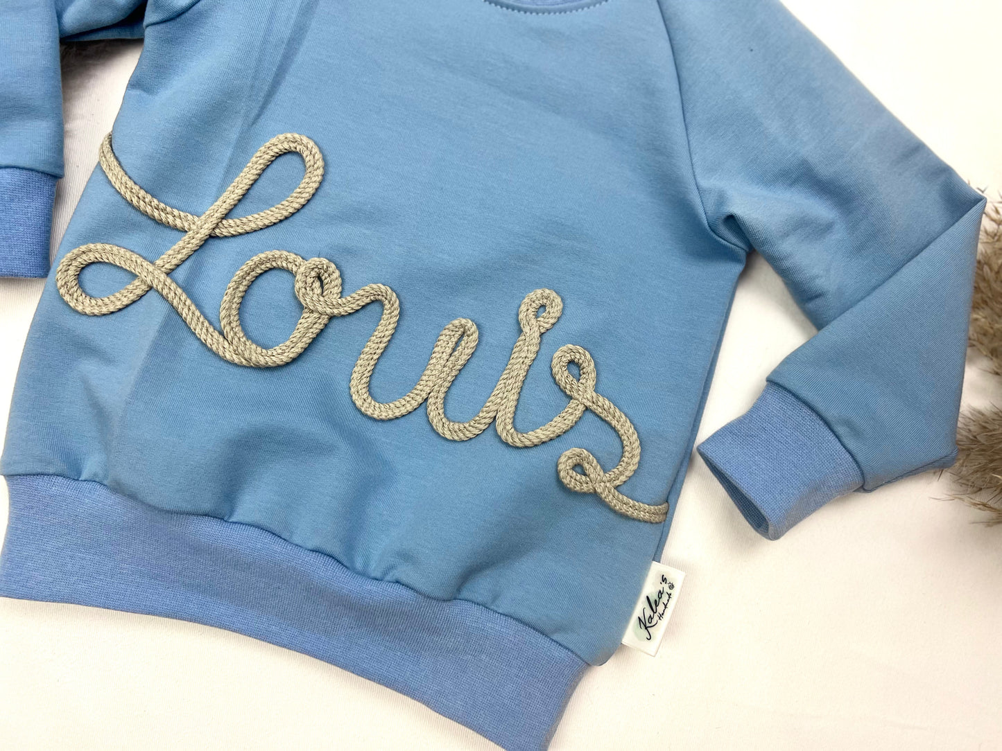 Sweater mit Kordelapplikation